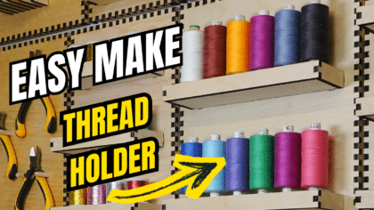 YouTube thumbnail showing a laser‑cut plywood French cleat thread holder on a wall, with colourful thread spools on two shelves and bold text reading “Easy Make Thread Holder” with a yellow arrow pointing to the holder.