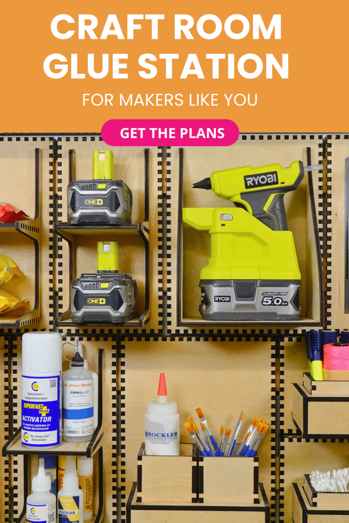 Laser‑cut plywood French cleat glue station on a craft room cleat wall, holding a cordless glue gun, batteries, glue bottles, activator and brushes in open-front compartments.