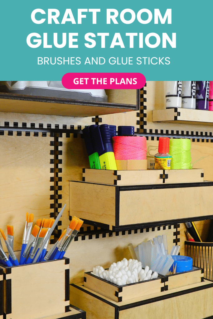 Laser‑cut plywood French cleat glue station on a craft room wall, with open-front boxes holding paintbrushes, cotton swabs, glue sticks and neon twine.