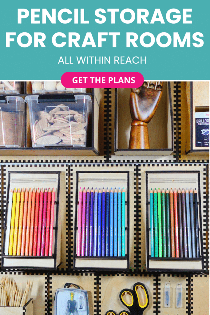 Laser‑cut plywood French cleat pencil holders on a craft room wall, each tray displaying neat rows of coloured pencils beneath clear storage tubs and a wooden articulated hand.