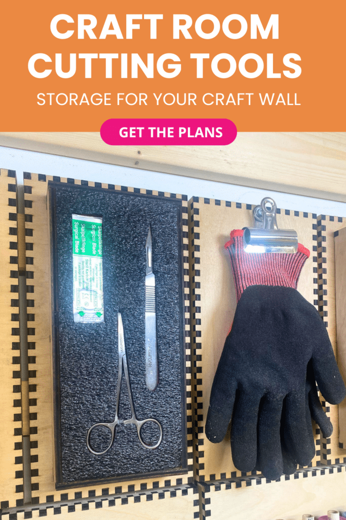 Laser-cut French cleat cutting tools panel on a plywood wall, with a Shadowfoam insert holding suturing tools and spare blades next to a clip holding a single black anti‑cut glove.