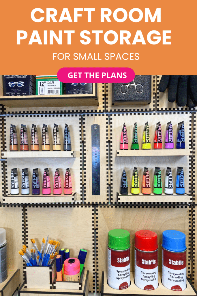 Laser-cut French cleat paint storage holders on a plywood wall, shown straight-on with rows of acrylic paint tubes, brushes, and spray paint cans neatly organized.