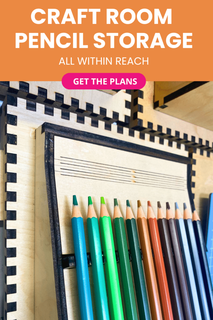 Laser‑cut plywood French cleat pencil holders on a craft room wall, showing an angled tray filled with neatly arranged coloured pencils.