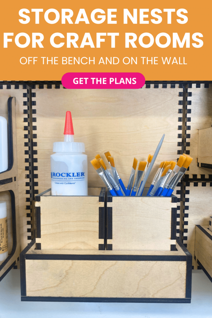 Laser-cut French cleat storage nest on a plywood wall, with stepped wooden compartments holding a glue bottle and paintbrushes to keep small craft supplies off the bench.