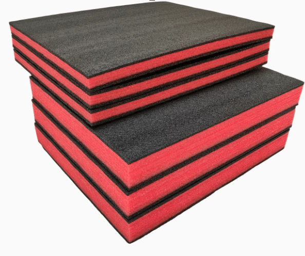 Two stacks of red and black multi-layered high-density foam blocks, such as Shadowfoam or Kaizen foam, used for custom tool organization. This material is designed for precision tool nesting within workshop storage systems like the Neat French Cleat Gallery Frames, allowing makers to create a professional, flush-fit finish for their tool walls.