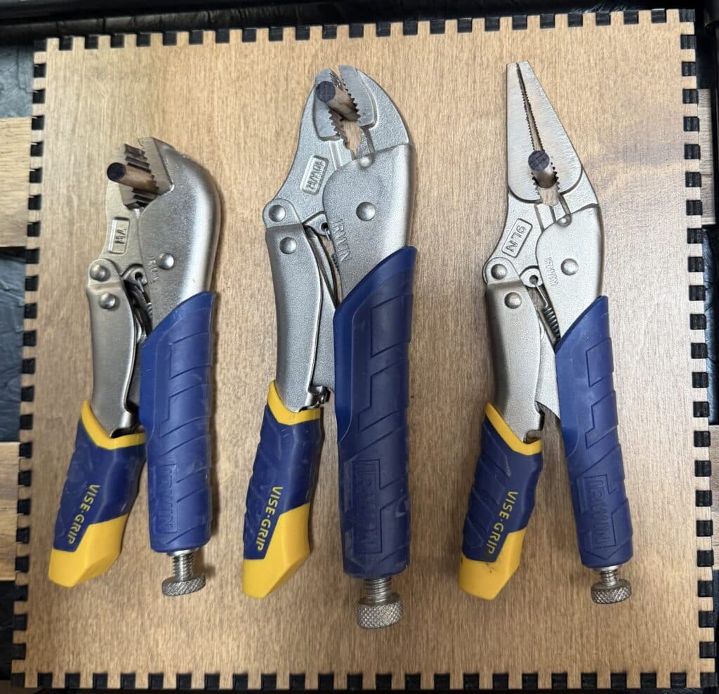 Three Vise-Grip locking pliers in graduated sizes standing side by side on a French Cleat panel.